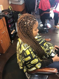 a woman sitting in a chair at a hair salon