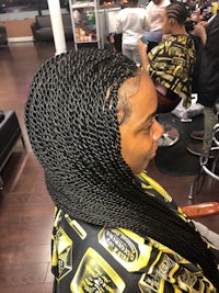 a woman with braided hair in a salon